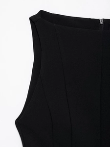 Detailed view of women's black dress neckline with a metallic back zipper closure