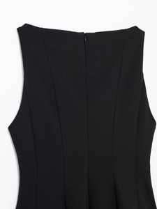 Detail of a black sleeveless dress showing the invisible back zipper and slim fit seams