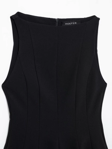 Detail view of black boat neck sleeveless dress featuring vertical seams and back zipper