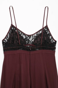 Détail de la robe bordeaux avec bordure en dentelle noire et fines bretelles réglables