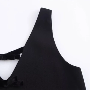 Elegant black velvet bow detail on the shoulder of a sleeveless straight mini dress