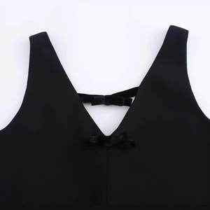 Women black V-neck velvet dress with bow details on the neckline in a flat lay view