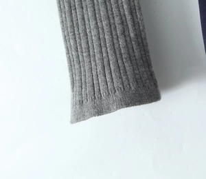 Detailed macro view of the grey ribbed knit cuffs and soft fabric texture of the dress