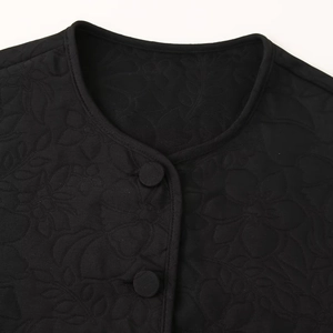 Women's black quilted floral jacket featuring round neck and matching fabric buttons