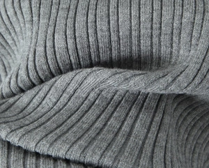 Detailed macro view of the grey ribbed knit fabric showing soft vertical textures