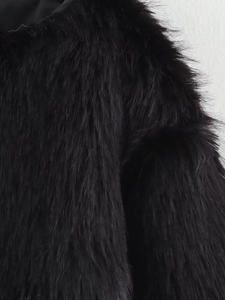 Detailed macro view of high-quality dense black faux fur texture with glossy finish