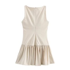 Detail of a beige sleeveless mini dress featuring fine pleated hem and hidden back zipper