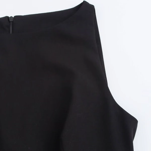Detail of a black sleeveless mini dress featuring a neat back zipper and smooth woven fabric