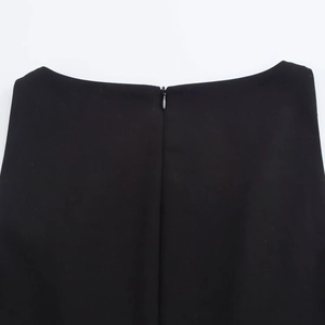 Close-up of the smooth black woven fabric with a hidden metal olive zipper on the waist