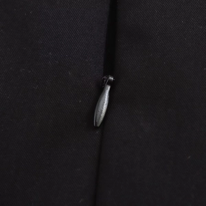 Macro detail of high-quality invisible zipper on the side of a black woven dress