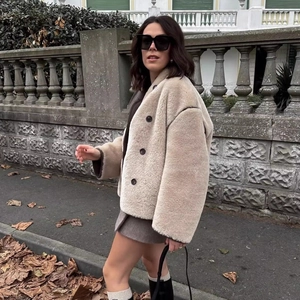 Chic beige faux fur double-breasted jacket for women styled with a short brown skirt
