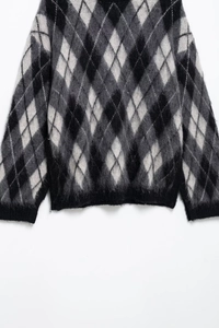 Detailansicht aus weichem Strickgewebe mit klassischem einfarbigem Argyle-Rautenmuster