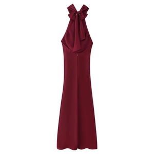 Detail of burgundy halter neck dress featuring a large bow and elegant open back