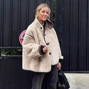 Women's cream faux shearling jacket with brown leather trim in a stylish oversized fit