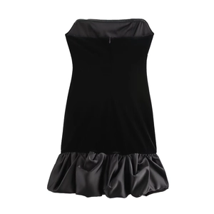 Detail of velvet bodice and satin ruffled hem on a black off-shoulder dress with zipper
