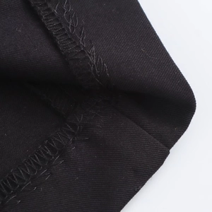 Detail of professional black twill fabric stitching and overlock seam workmanship