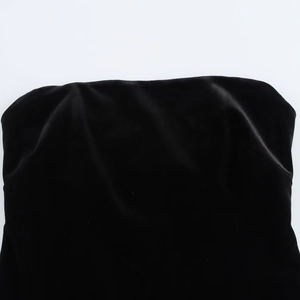 Detail shot of black velvet fabric texture on a strapless dress with subtle luster