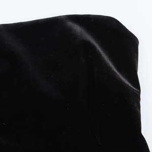 Detailed view of luxury black velvet fabric showing soft texture and natural drapes