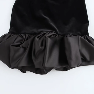 Detailed view of the velvet and satin patchwork hem with ruffled pleat texture