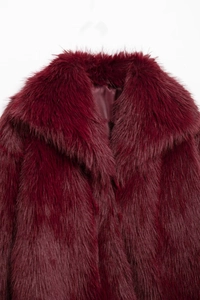 Detailed close-up of dark red faux fur coat showing plush texture and smooth satin lining