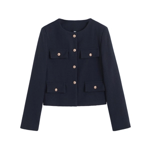 Detailed close-up of tweed jacket texture with golden buttons and round neck design