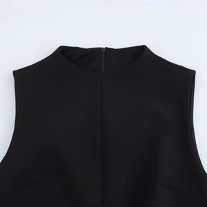 Detailed view of the round neckline and rear zipper of this black sleeveless dress