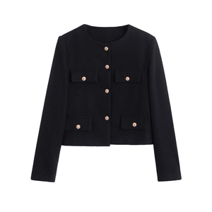 Close-up of vintage gold metal buttons on a black tweed round neck jacket for women