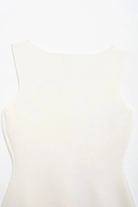 Detail shot of cream-colored sleeveless knit vest featuring fine vertical ribbed texture