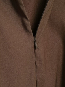 Detailed close-up of dark brown twill fabric featuring a seamless invisible zipper