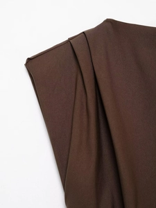 Detail shot of pleated shoulder design on a dark brown top with subtle sheen finish