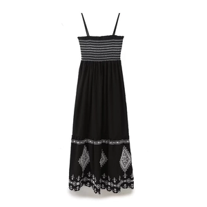 Bohemian black maxi dress with white embroidery and elegant scalloped hemline