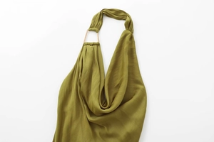 Close-up of olive green cowl neck dress with silky texture and gold metal ring detail