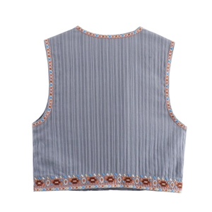 Close-up of ethnic embroidery detail on gray sleeveless linen vest back with stripe texture