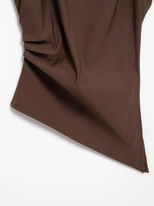 Detail of dark brown top featuring side ruching and asymmetric hem on white background