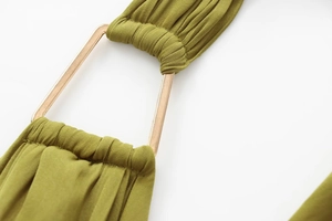 Close-up of olive green satin dress with gold metal ring buckle and pleated fabric details