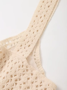 Detailed macro view of the beige crochet diamond pattern stitching with soft inner lining