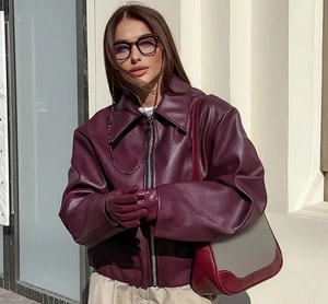 Detail of burgundy oversized PU leather jacket with metal zipper and turn-down collar
