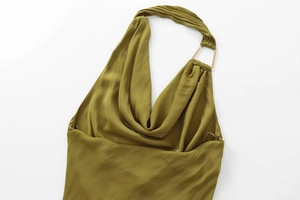 Detail view of cowl neck draping and gold metal buckle on olive green satin dress