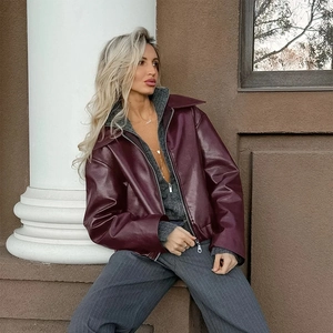 Detail of burgundy leather jacket with oversized lapels and street style texture