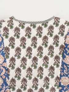 Detail of diamond quilted jacket with mixed floral patterns and striped trim details