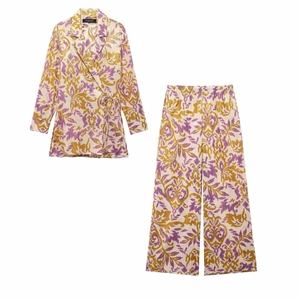 Detail of bohemian print two-piece set featuring pleated texture and gold patterns