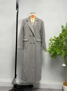 Detailed view of grey wool coat featuring notched lapels and double breasted buttons