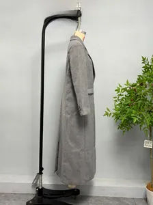 Detail view of grey long wool coat sleeve with three black buttons on cuff