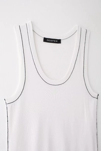 Detail of white rib-knit tank top featuring black contrast stitching and U-shaped neckline