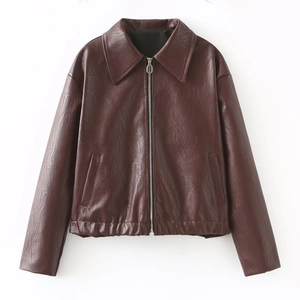 Close-up of wine red faux leather jacket featuring metal zipper and elastic hem detail