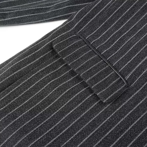 Close-up of high-quality stitching on dark grey pinstripe wool coat fabric details