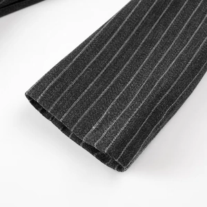 Close-up of the dark grey pinstriped knit wool coat cuff showing fine fabric texture