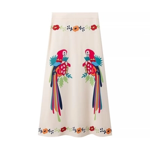 Detail view of high waist floral skirt with vibrant parrot prints and ruffles