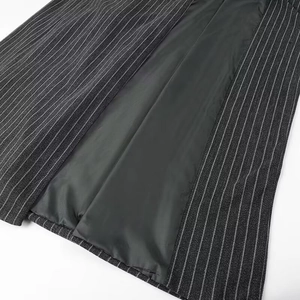 Detailed macro view of dark grey pinstripe fabric and smooth black inner lining