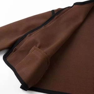 Detailed macro view of dark brown wool jacket interior with black pocket and refined texture
